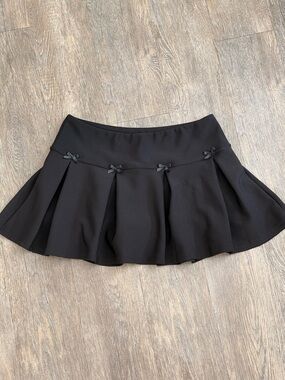 Black Pleated Mini Skirt with Decorative Bows